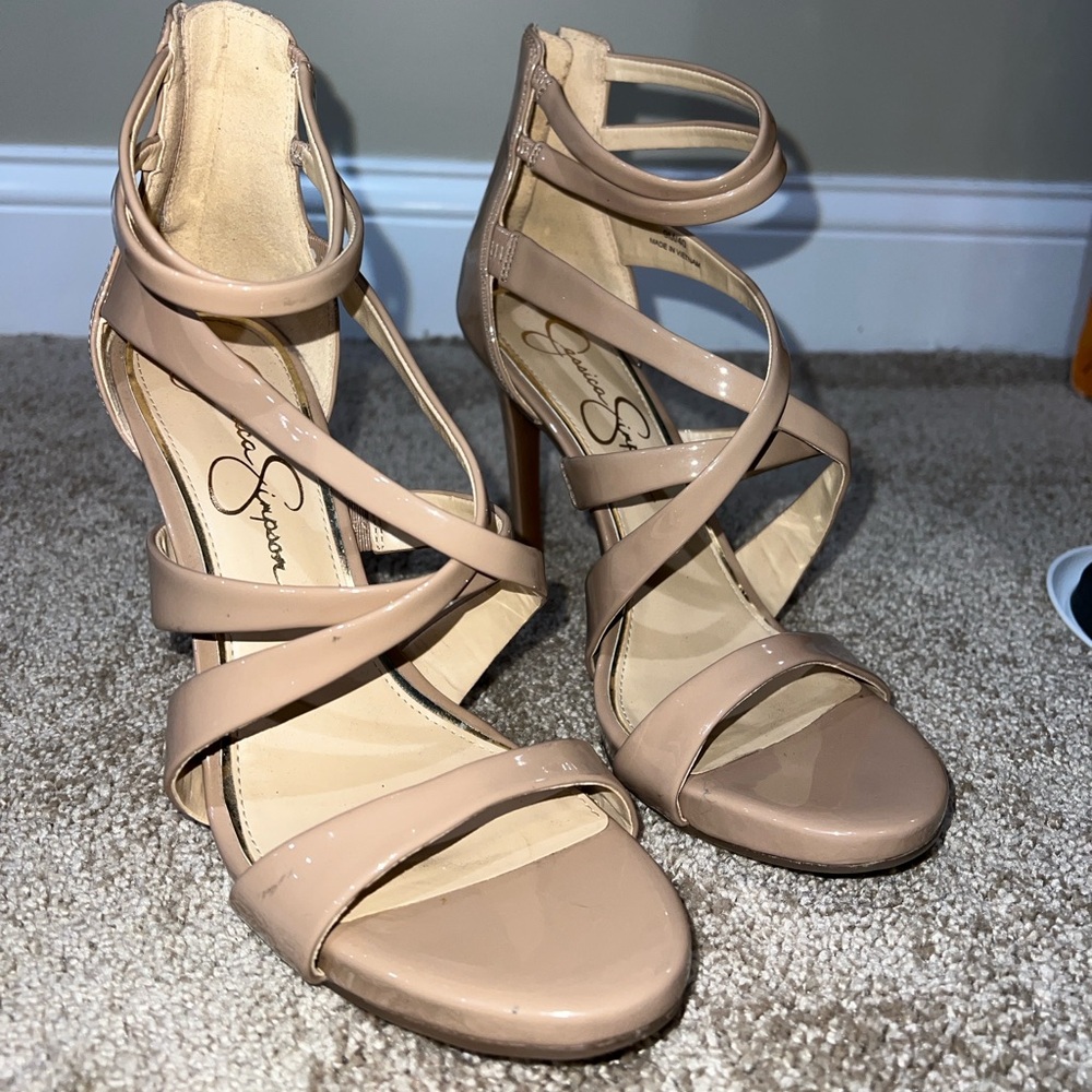 Never worn strappy 4.5 inch heels with a zipper back. Fits true to size.